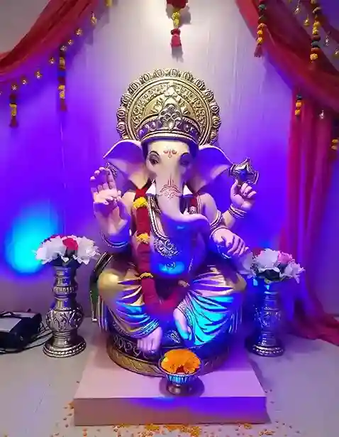 Ganesh Chaturthi decoration with golden drapes, flowers, and traditional Ganpati idol | Ganesh Chaturthi Draped Decoration | Festival Decorations | Decorations Guru